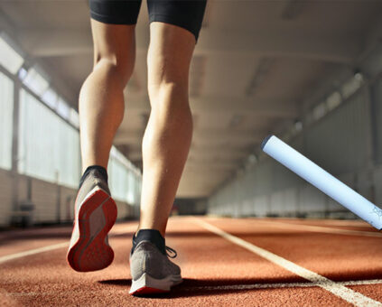 legs of a runner on a track with a picture of an e-cigarette at the bottom right side
